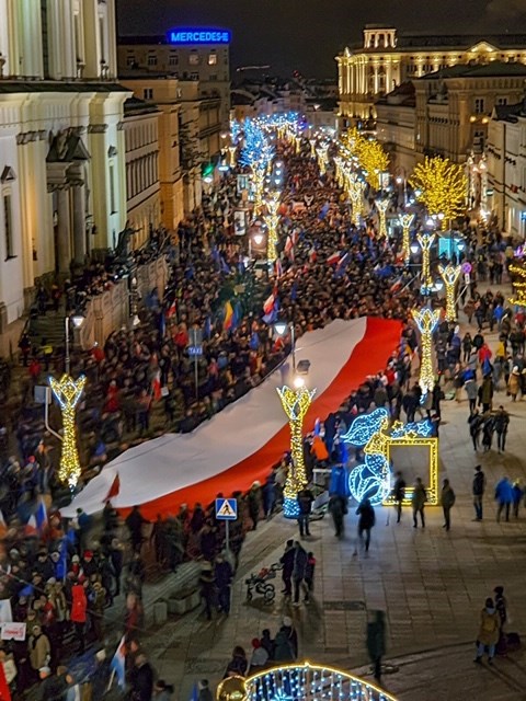 Aftenbillede af stor demonstration med mange deltagere, der fylder gaden